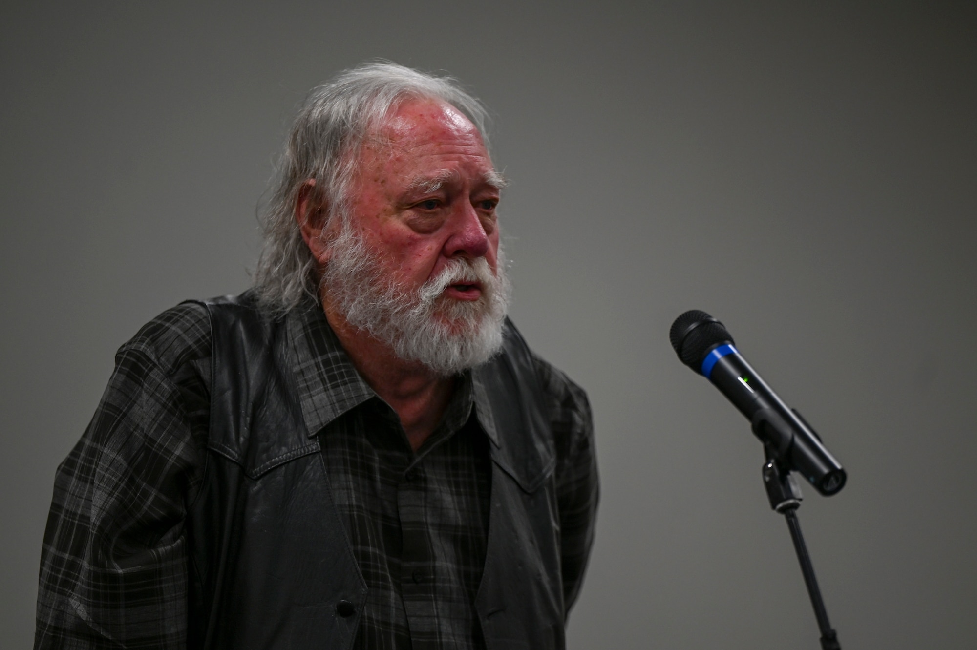 A man speaking at a microphone