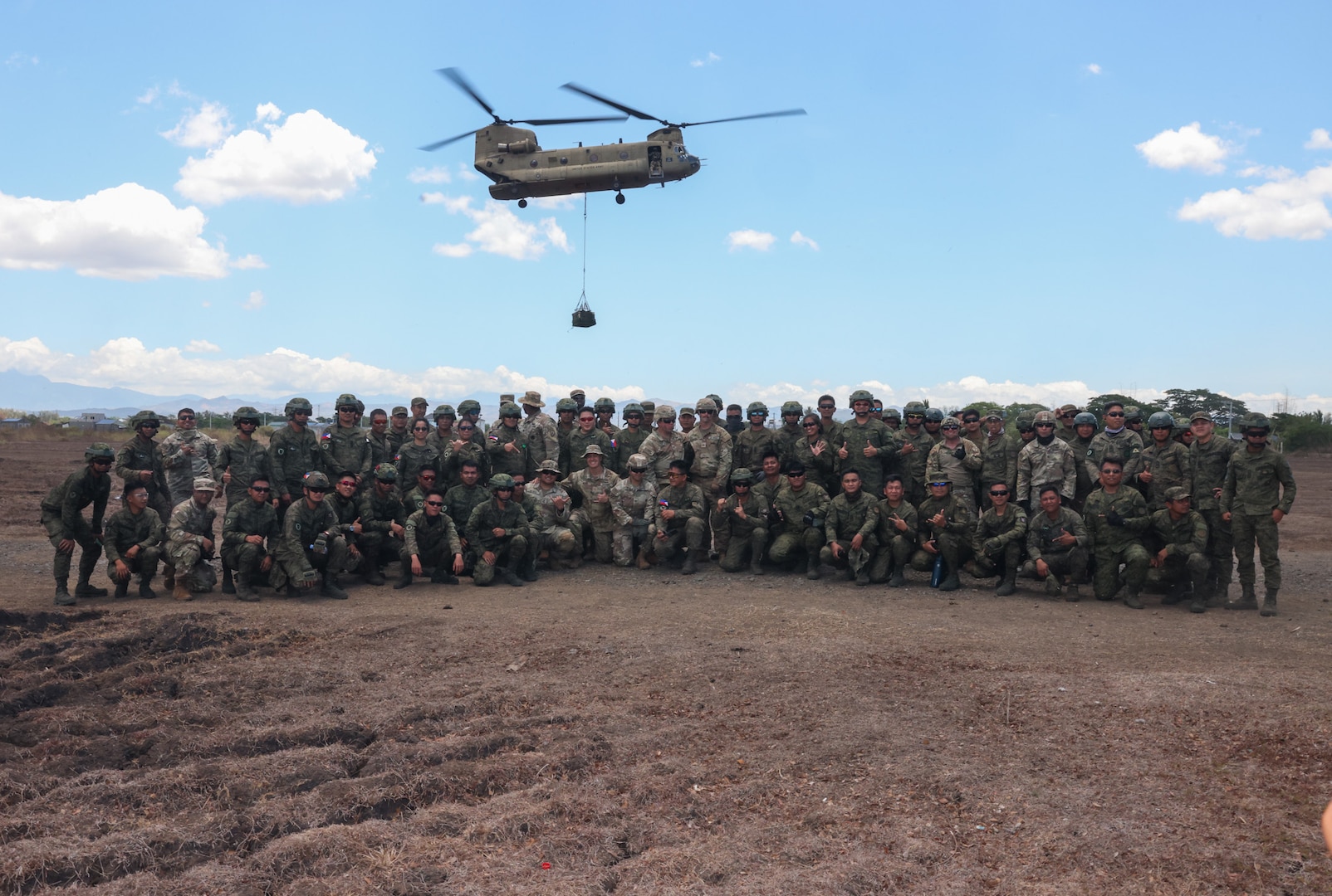 U.S. Army Soldiers from the 25th Infantry Division Sustainment Brigade, 25th Infantry Division, alongside Philippine Army Soldiers from the 7th Service Support Battalion, Army Support Command, and Special Forces Regiment Airborne pose for a group photo following a sling load operations training activity in support of Exercise Balikatan 24 at Fort Magsaysay, Philippines, April 22, 2024. BK 24 is an annual exercise between the Armed Forces of the Philippines and the U.S. military designed to strengthen bilateral interoperability, capabilities, trust, and cooperation built over decades of shared experiences. (U.S. Army Photo by Spc. Kai Rodriguez, 28th Public Affairs Detachment