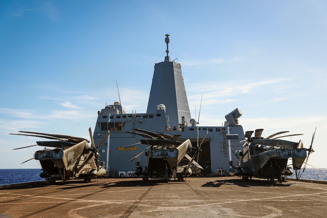 U.S. Marines assigned to Marine Medium Tiltrotor Squadron (VMM) 165 (Reinforced), 15th Marine Expeditionary Unit, prepare CH-53E Super Stallions attached to VMM-165 (Rein.), 15th MEU, for flight operations aboard the amphibious transport dock USS Somerset (LPD 25) in the South China Sea April 11, 2024. Somerset and embarked elements of the 15th MEU are conducting routine operations in the U.S. 7th Fleet area of operations. 7th Fleet is the U.S. Navy's largest forward-deployed numbered fleet, and routinely interacts and operates with allies and partners in preserving a free and open Indo-Pacific region. (U.S. Marine Corps photo by Cpl. Aidan Hekker)
