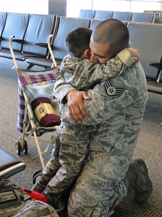 U.S. Air Force Master Sgt. Justin Canizales, 51st Security Forces Squadron plans and programs superintendent, embraces his son, Ayden, at the airport in 2012. Canizales has served in two deployments and three short tour assignments. Month of the Military Child is commemorated annually to reignite the dedication and resilience of military children, and provides various resources for military families to build connections. (U.S. Air Force courtesy photo)