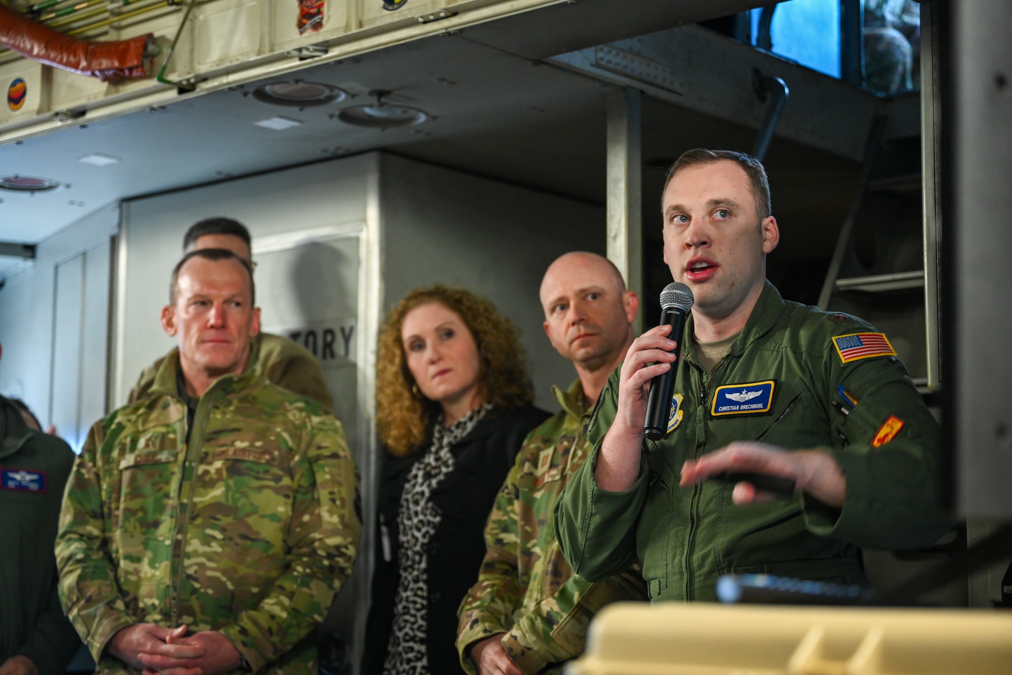 Maj. Christian Brechbuhl, right, Air Mobility Command mission systems deputy director, briefs senior leaders about the Airlift Tanker Open Mission Systems program on a C-17 Globemaster III April 24, 2024, on the flightline at Ramstein Air Base, Germany.