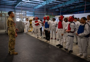 U.S. Air Force Senior Airman Shaun Jones, 436th Security Forces Squadron Phoenix Raven, briefs a group of Air Force Junior ROTC cadets before a sparring session at Dover Air Force Base, Delaware, April 24, 2024. The JROTC cadets toured Dover AFB to gain a better understanding of the jobs and duties of the 436th SFS and 436th Force Support Squadron. (U.S. Air Force photo by Airman 1st Class Amanda Jett)