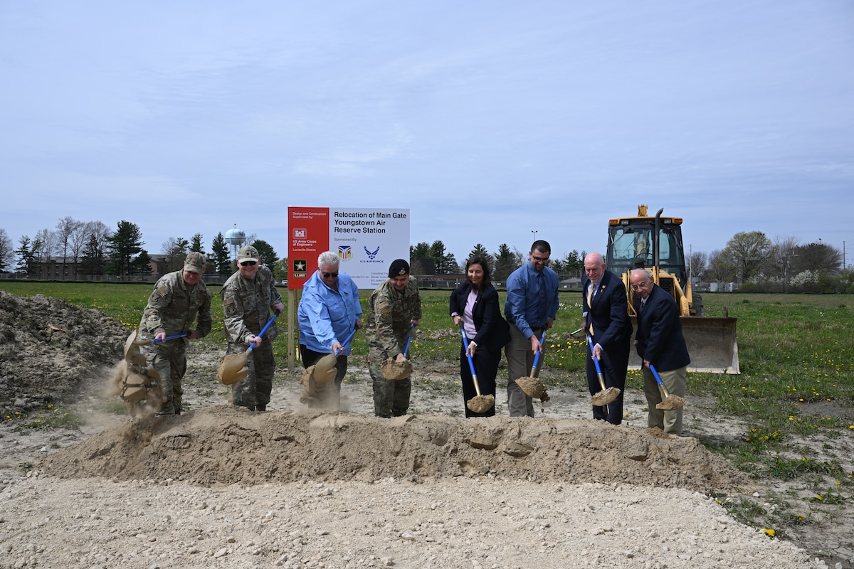 A group of people turn shovels to mark the groundbreaking for the main gate relocation and upgrade project at Youngstown Air Reserve Station, Ohio, April 23, 2024.