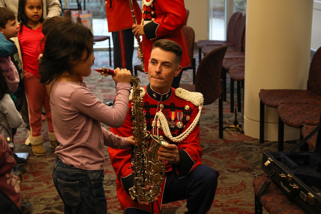 Staff Sgt. Connor Mikula interacts with audience member during the instrument petting zoo held at the Young People's Concert on Feb. 10, 2024.