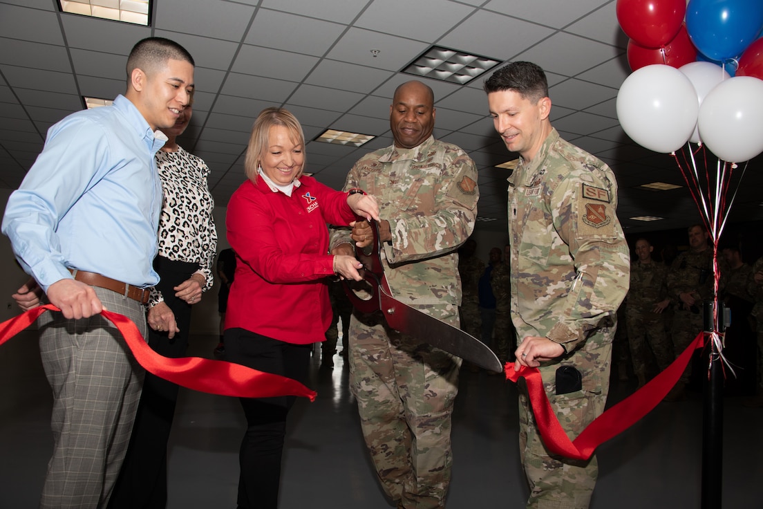 Members from the 316th Wing and the Army & Air Force Exchange Service cut a ribbon for the unveiling of a new unattended retail unit at Joint Base Andrews, Md., April 25, 2024.