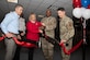 Members from the 316th Wing and the Army & Air Force Exchange Service cut a ribbon for the unveiling of a new unattended retail unit at Joint Base Andrews, Md., April 25, 2024. The unattended retail unit will be open 24-hours, providing food options for shift workers with the 316th Security Forces Group. (U.S. Air Force photo by Senior Airman Daekwon Stith)