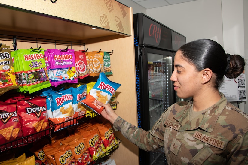 U.S. Air Force Senior Airman Kendra A. Alicea Rosa browses food options at the new 24/7 unattended retail unit at Joint Base Andrews, Md., April 25, 2024.