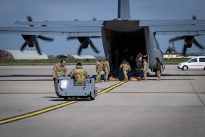 Military moves a cart onto an airplane