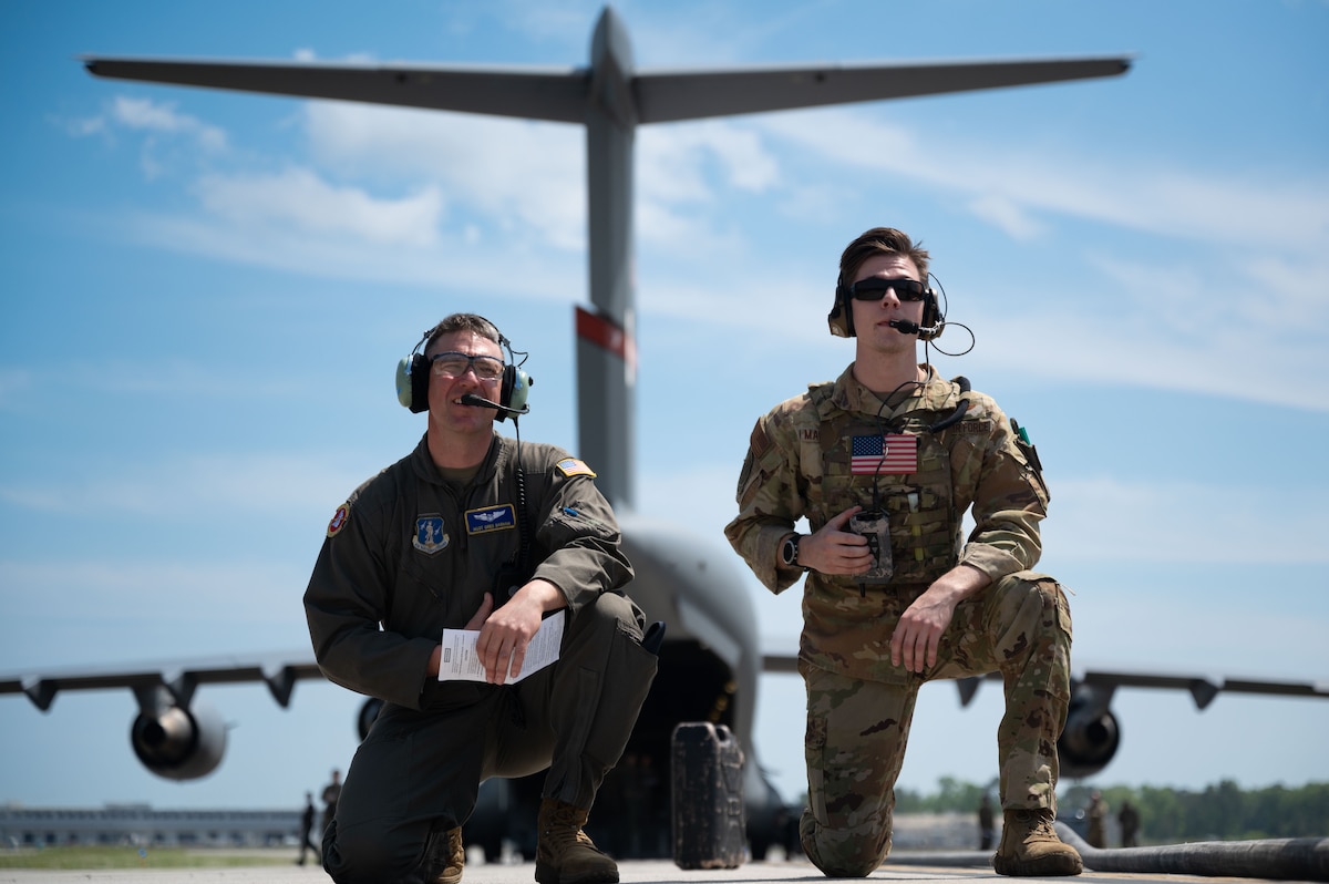 Master Sgt. Greg Barham, 167th Airlift Wing instructor loadmaster, and Staff Sgt. Christian Magliocca, 15th Airlift Squadron instructor loadmaster, await refueling operations to complete during the Forward Area Refueling Point Rodeo at Joint Base Charleston, S.C., April 2, 2024. By conducting FAPR training, C-17 Globemaster III crews develop a greater agility and ability to quickly respond and provide global power projection under the cover of darkness in austere environments. (U.S. Air Force photo by Staff Sgt. Spencer Slocum)