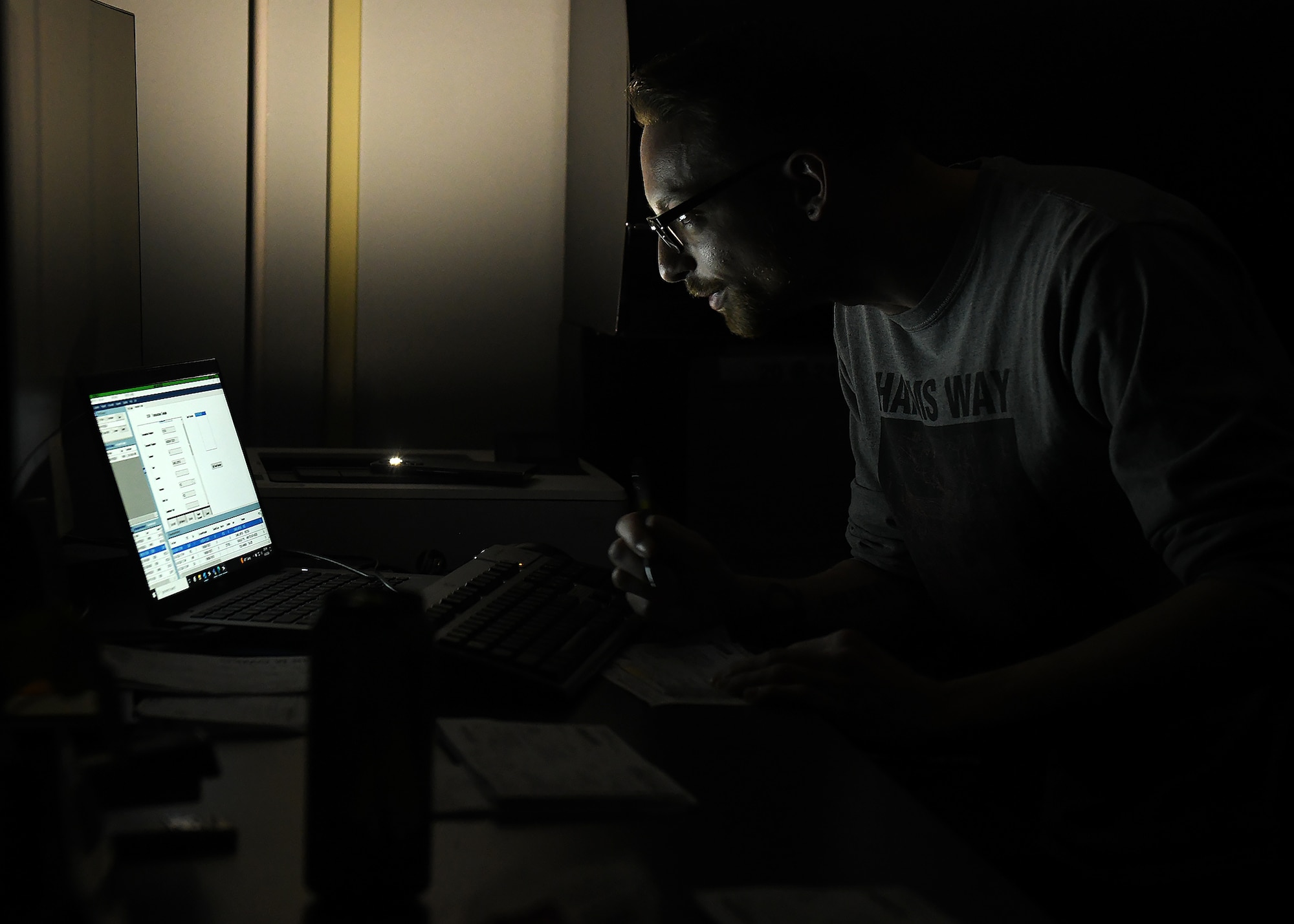 Civilian working in the dark during a military exercise