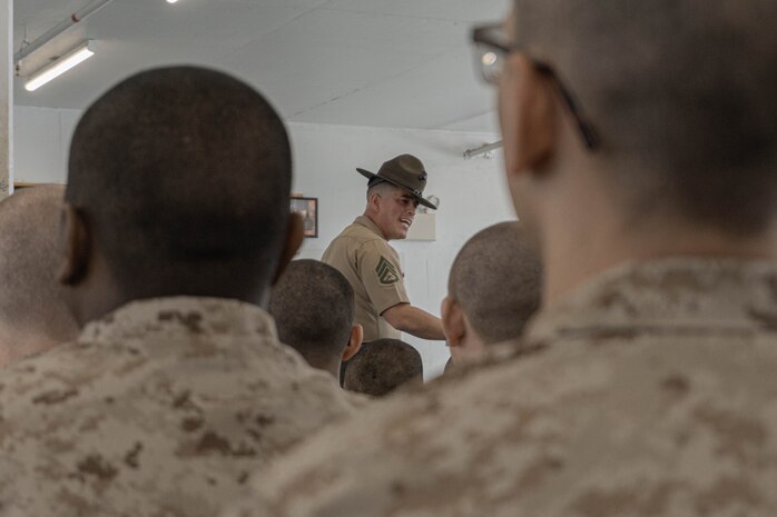 U.S. Marine Corps Staff Sgt. Gustavo Felix, a senior drill instructor with India Company, 3rd Recruit Training Battalion, gives instructions during pick up at Marine Corps Recruit Depot San Diego, California, April 19, 2024. Pick up is when recruits are introduced to their drill instructors and gain an understanding of the rules and expectations set for their training. (U.S. Marine Corps photo by Lance Cpl. Alexandra M. Earl)