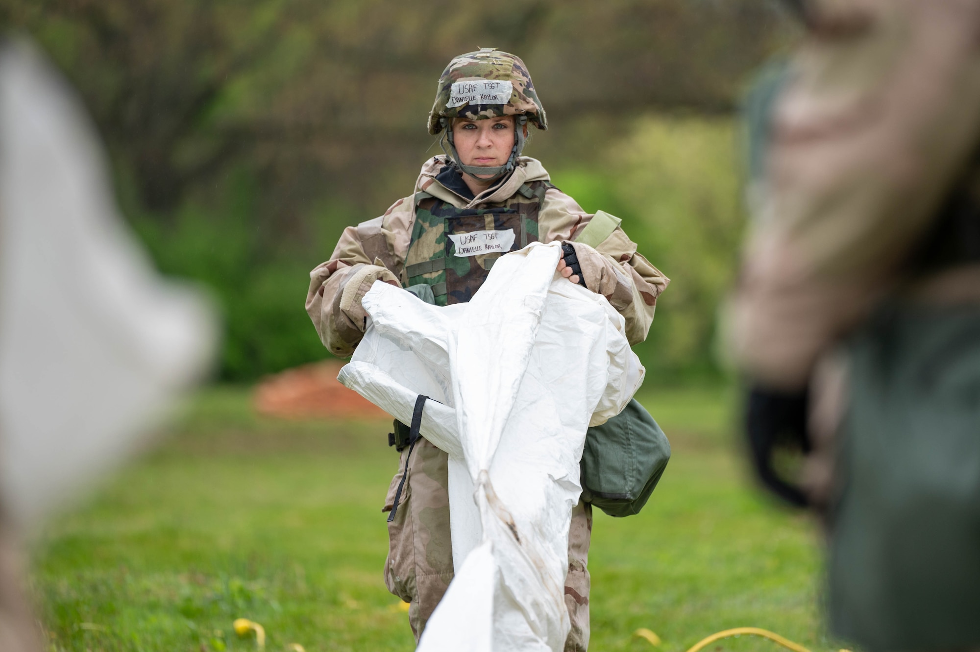 An Airman unfolds a liner for a Small Shelter System tent.