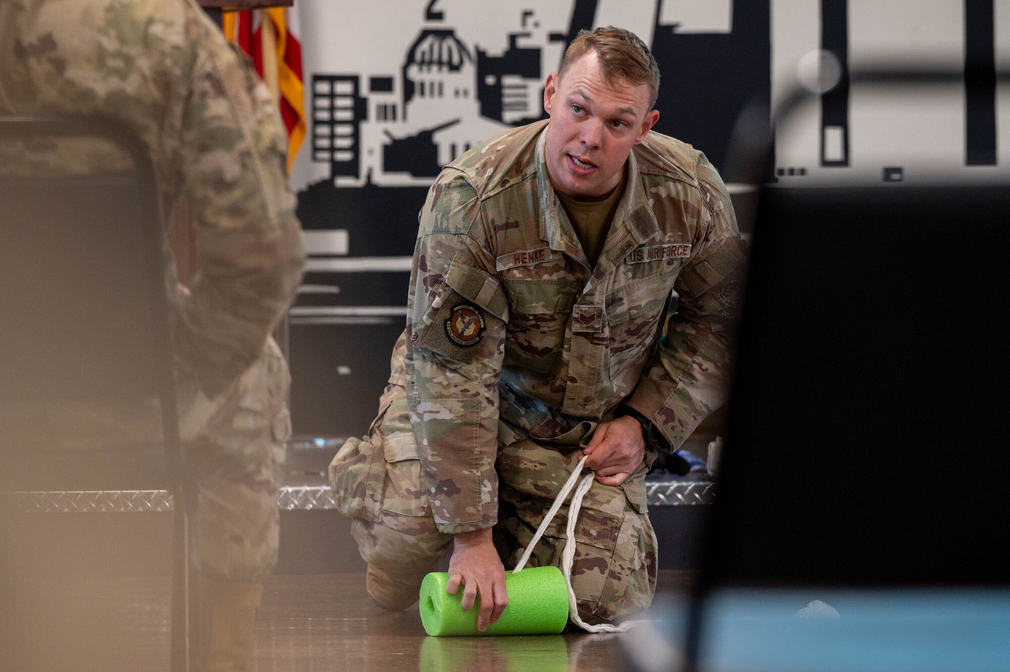 An Airman demonstrates packing a simulated wound.