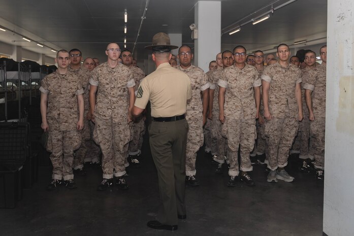 U.S. Marine Corps Staff Sgt. Gustavo Felix, a drill instructor with India Company, 3rd Recruit Training Battalion, gives instructions to the new recruits during pick up at Marine Corps Recruit Depot San Diego, California April 19, 2024. Recruits met their drill instructors and were briefed on the rules and expectations for their training (U.S. Marine Corps photo by Lance Cpl. Janell B. Alvarez)
