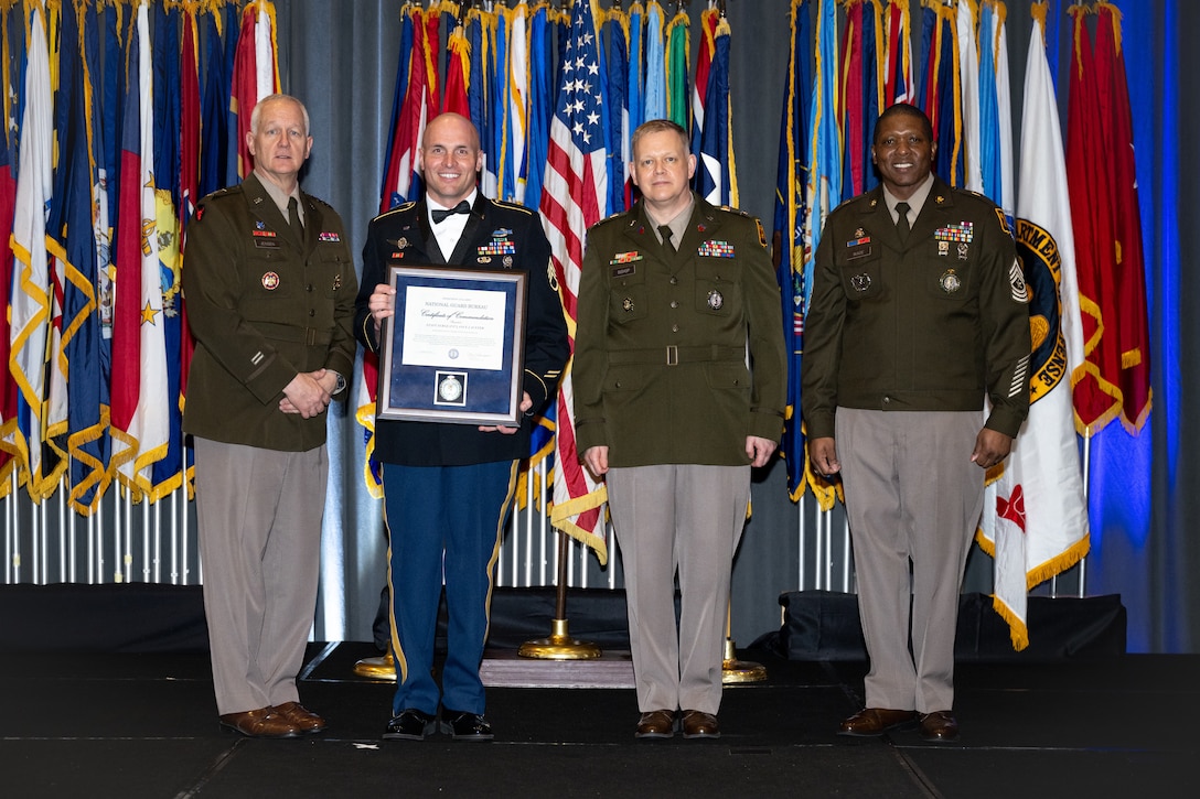 Staff Sgt. Lance Lauffer receiving a certificate of commendation at the Chief’s 54 awards ceremony March 14 in Houston. Also pictured are, left to right: Lt. Gen. Jon Jensen, director of the Army National Guard; Col. Andrew Bishop, chief of the Army National Guard Strength Management Division; and Sgt. Maj. Jabin Wade. Submitted photo