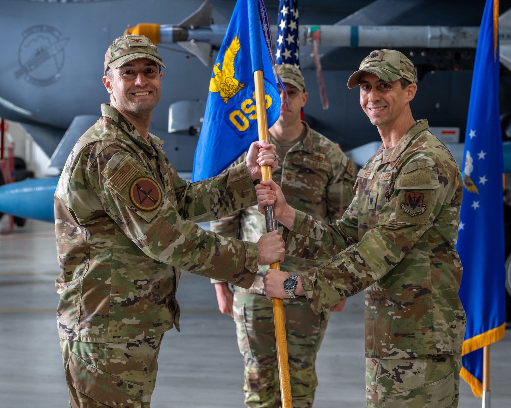 U.S. Air Force Col. Morgan Lohse, 4th Fighter Wing commander, relieves Lt. Col. Stephen Keefer of his duty as commander of the 4th Operational Support Squadron during a change of command ceremony at Seymour Johnson Air Force Base, April 22, 2024. The passing of the guidon serves as tradition to represent the change in commanders for the squadron.(U.S. Air Force photo by Airman 1st Class Leighton Lucero)