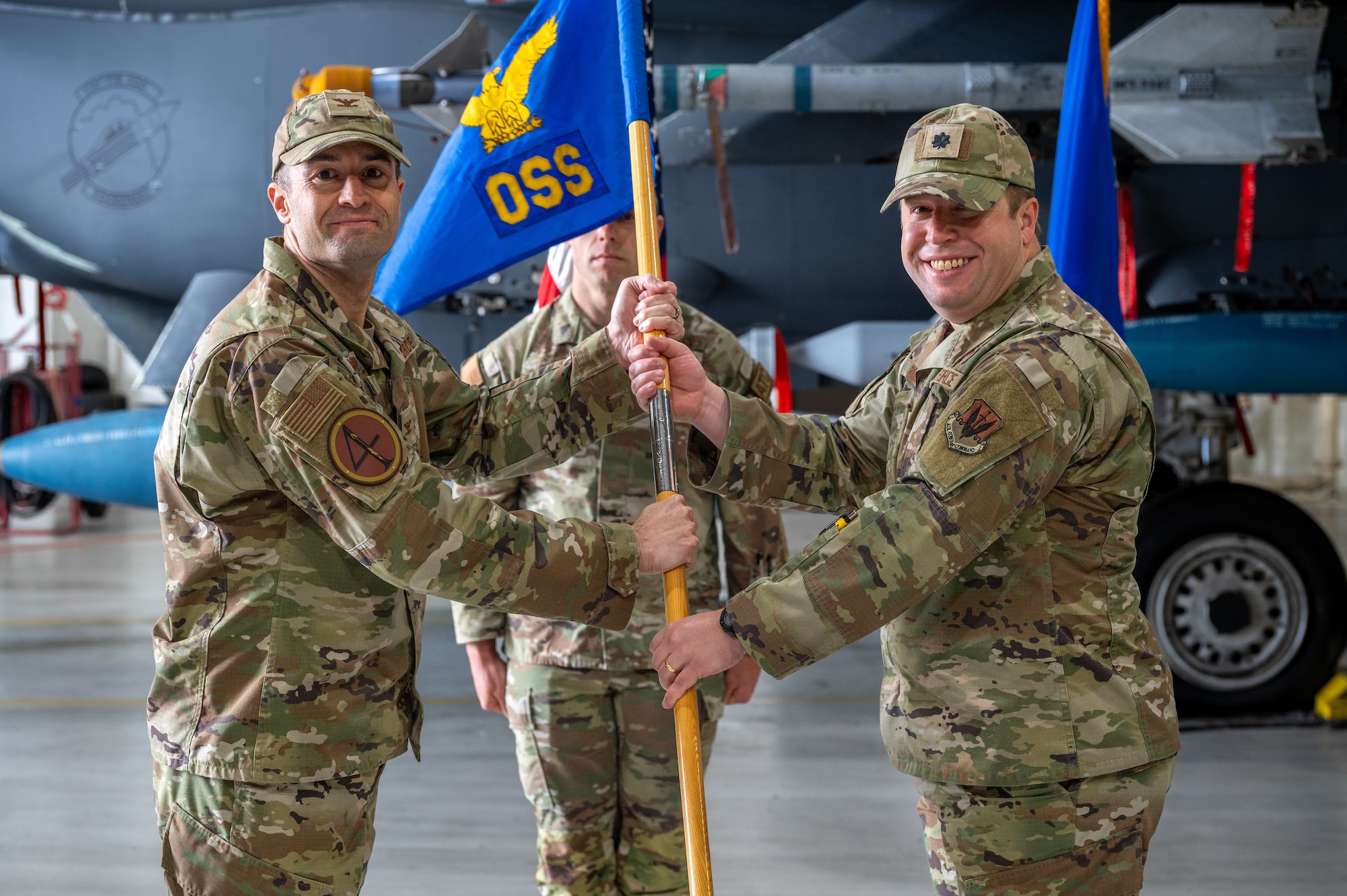 U.S. Air Force Col. Morgan Lohse, 4th Fighter Wing commander, appoints Lt. Col. Harry Starnes as the new commander of the 4th Operational Support Squadron during a change of command ceremony at Seymour Johnson Air Force Base, April 22, 2024. The passing of the guidon serves as tradition to represent the change in commanders for the squadron. (U.S. Air Force photo by Airman 1st Class Leighton Lucero)