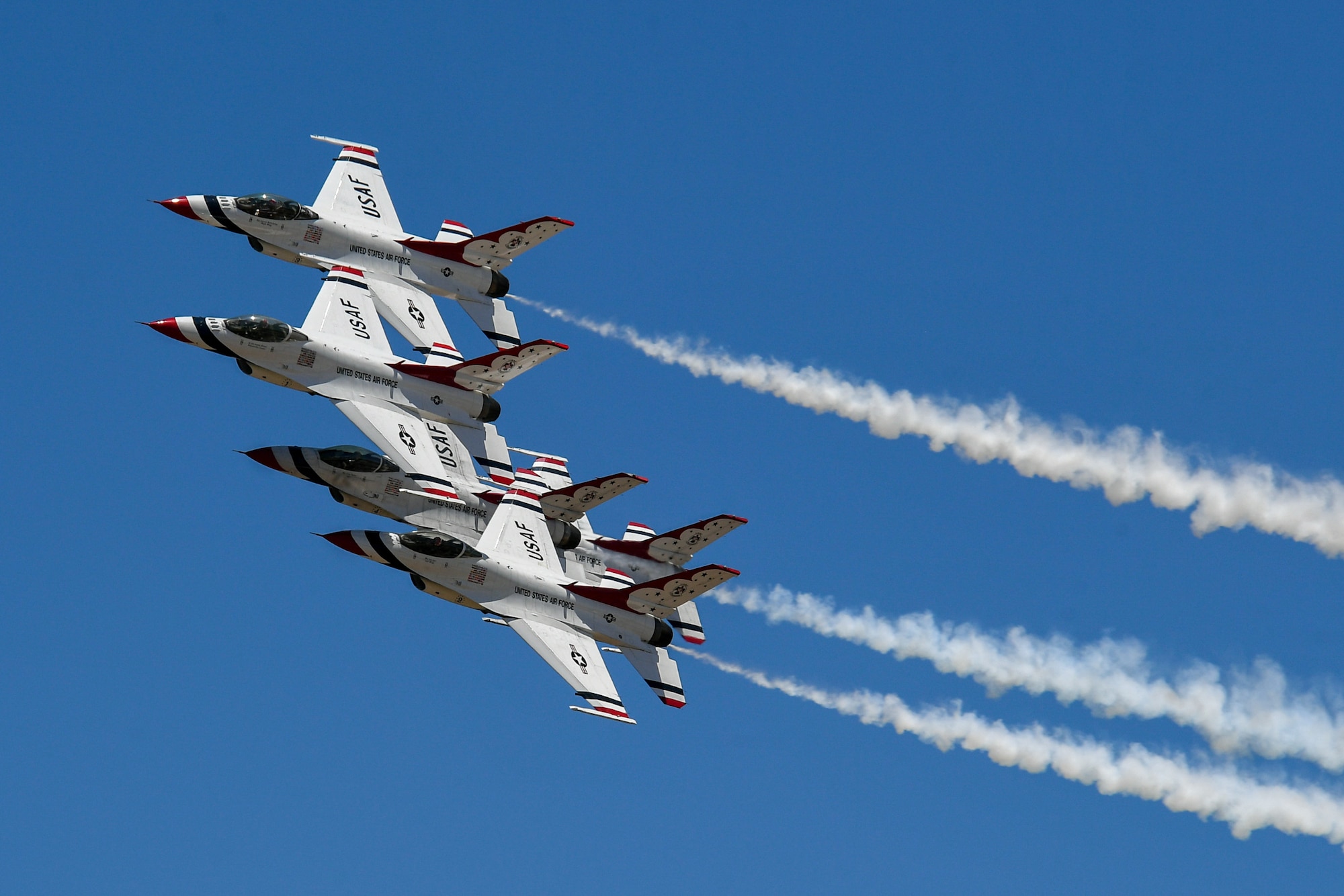 Four thunderbird aircraft fly in formation