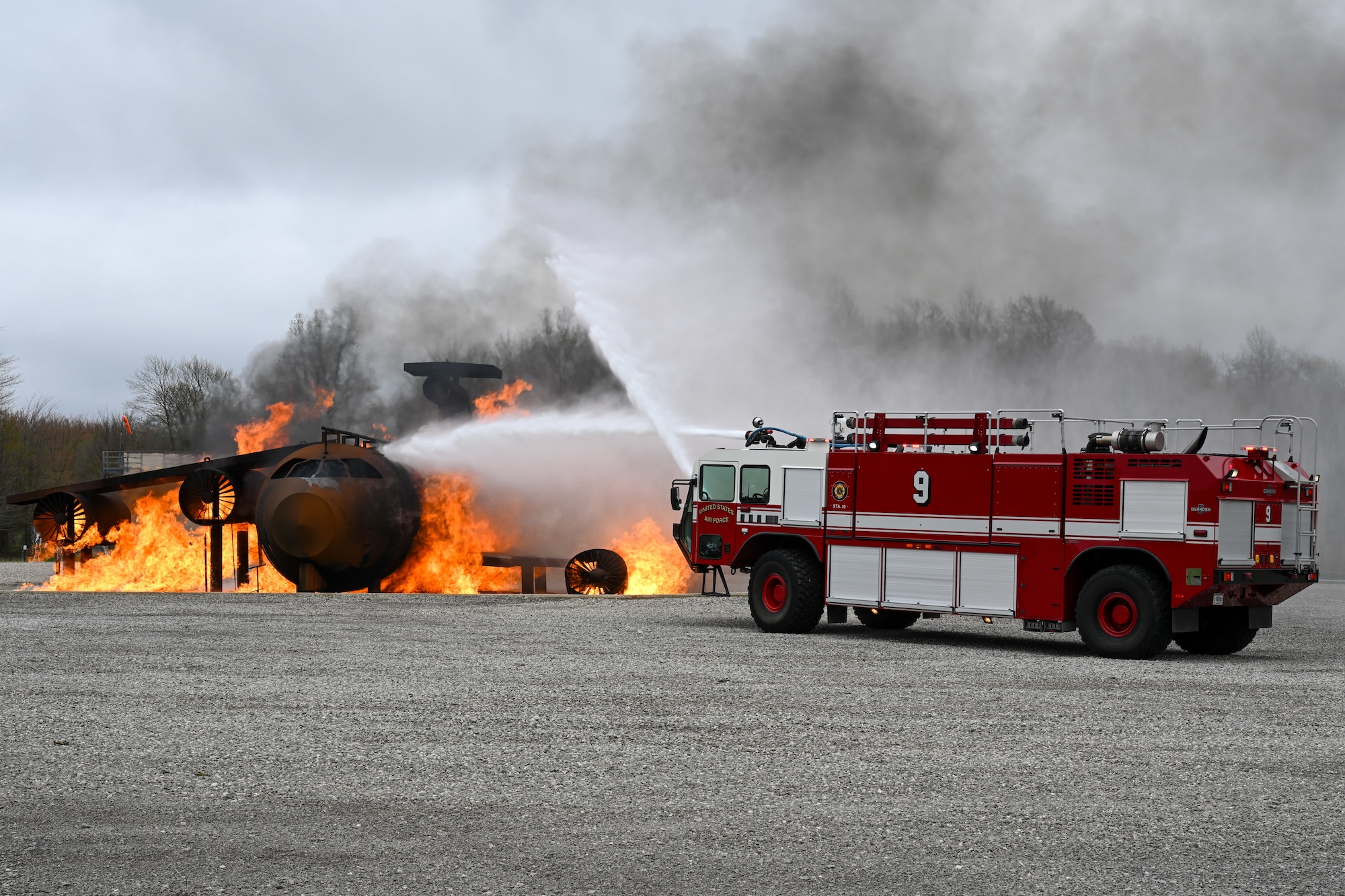 Fire engine 9 sprays water on a mock aircraft crash at the firefighter training area as base firefighters respond during an exercise at Youngstown Air Reserve Station, Ohio, April 25, 2024.