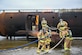 Youngstown Air Reserve Station firefighters approach the aircrew door while responding to a mock aircraft crash at the firefighter training area during an exercise at Youngstown Air Reserve Station, Ohio, April 25, 2024. The training area provides firefighters from the installation’s fire department, other Department of Defense agencies and surrounding communities the opportunity to train on live fires on the apparatus which replicates the design of several types of aircraft commonly in the area. (U.S. Air Force photo by Eric M. White)