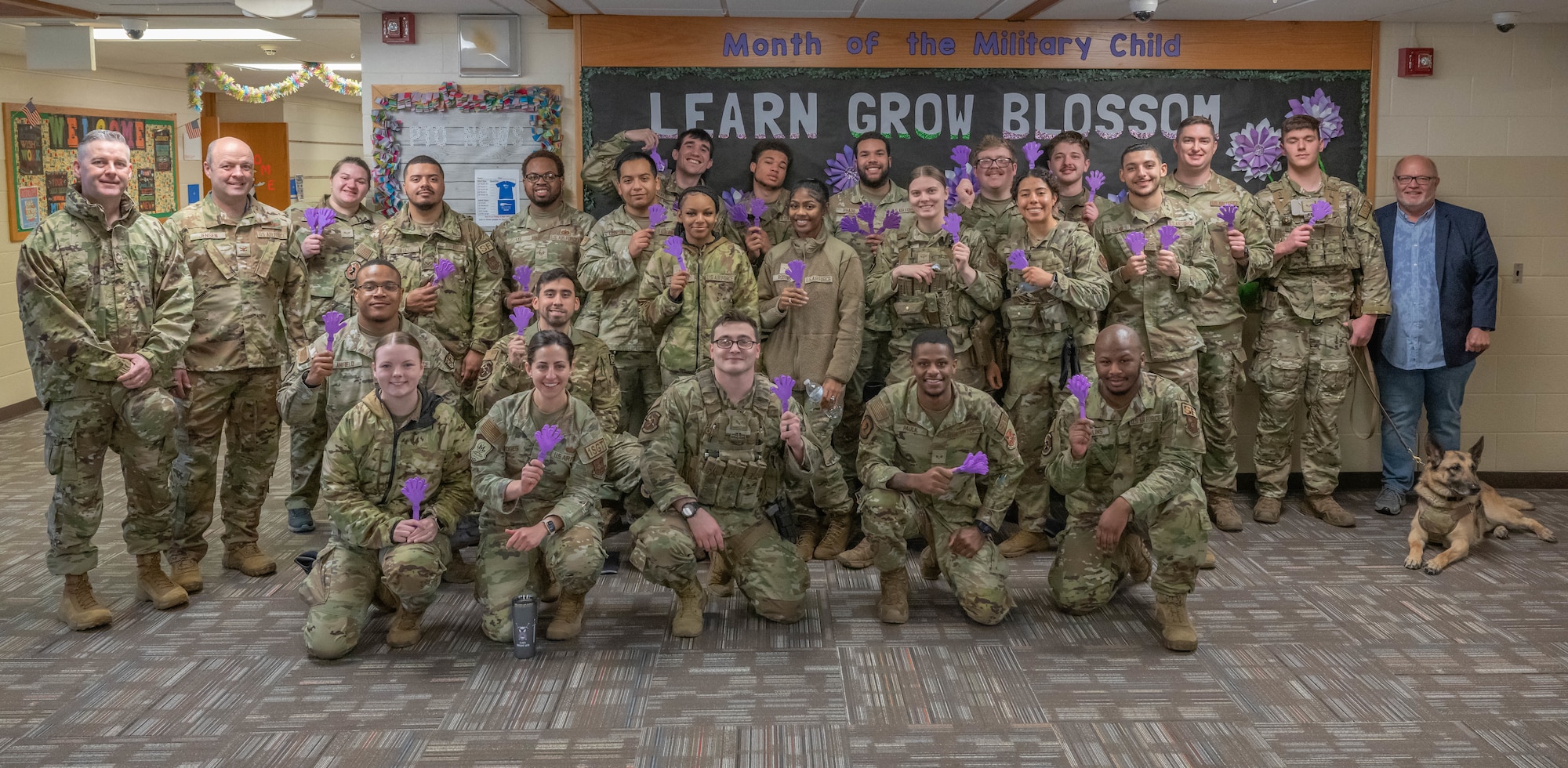 Team Minot Airmen pose for a photo at North Plains Elementary School, Minot Air Force Base, North Dakota. The Airmen were participating in a clap-in to honor students as part of the Month of the Military Child. (U.S. Air Force photo by Airman 1st Class Kyle Wilson)