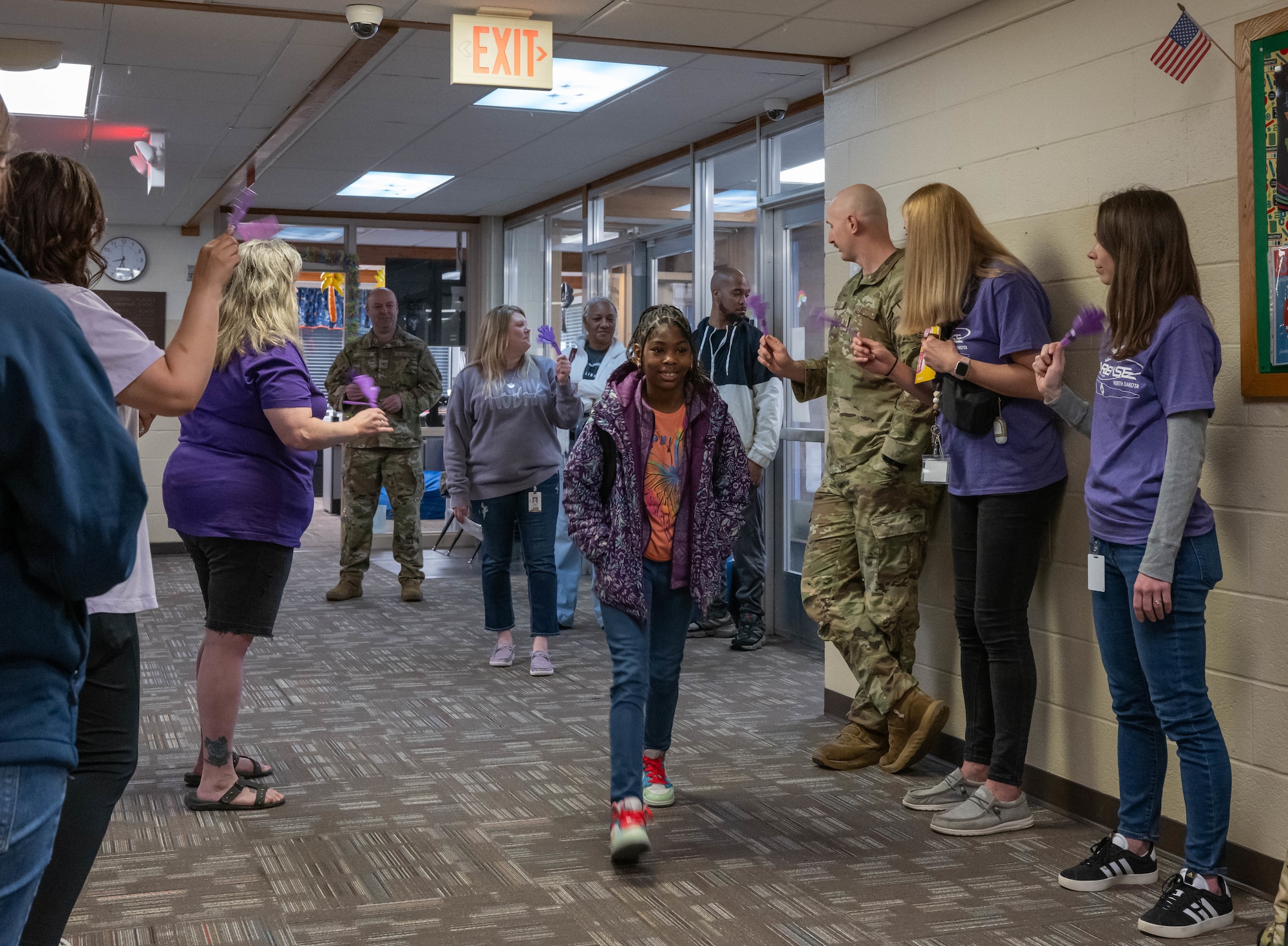 A student is welcomed to school by Team Minot Airmen and families during a clap-in at North Plains Elementary School, Minot Air Force Base, North Dakota, April 26, 2024.The clap-in was held to honor students in observance of the Month of the Military Child. (U.S. Air Force photo by Airman 1st Class Kyle Wilson)