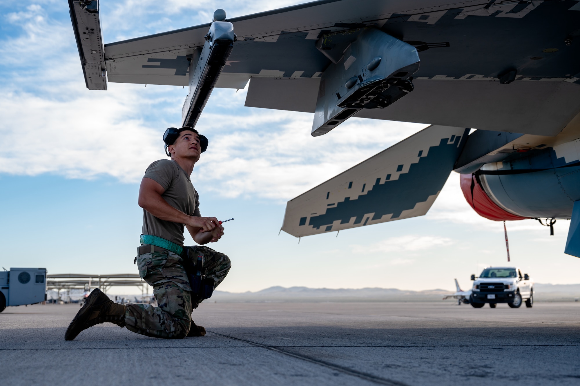 U.S. Air Force Senior Airman Devin Hubbard, a weapons load crew member assigned to the 57th Aircraft Maintenance Squadron Viper Aircraft Maintenance Unit, is conducting a check on a F-16C/D Fighting Falcon during a load competition at Nellis Air Force Base, Nevada, April 12, 2024.