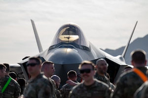 U.S. Air Force Airmen observe a load crew of the first quarter competition in front of an F-35A Lightning II at Nellis Air Force Base, Nevada, April 12, 2024.