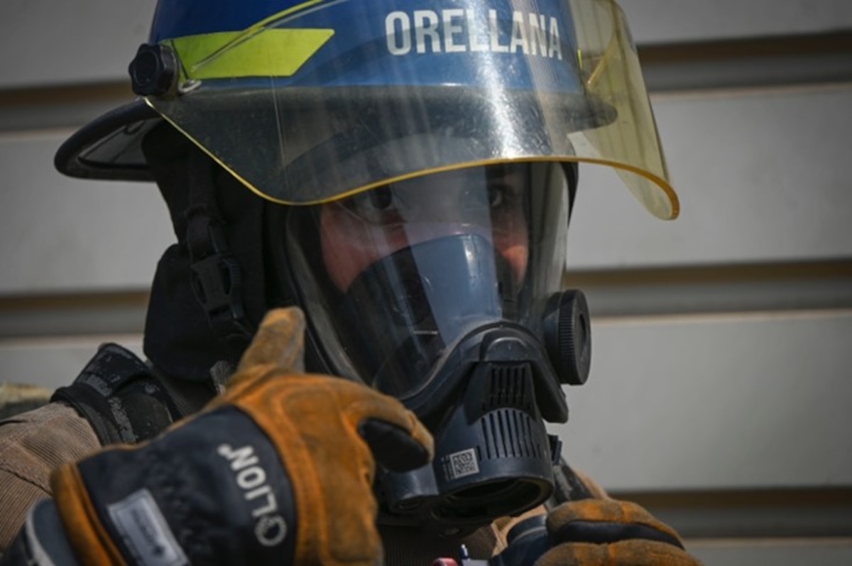 A photo of a firefighter with an oxygen mask on.