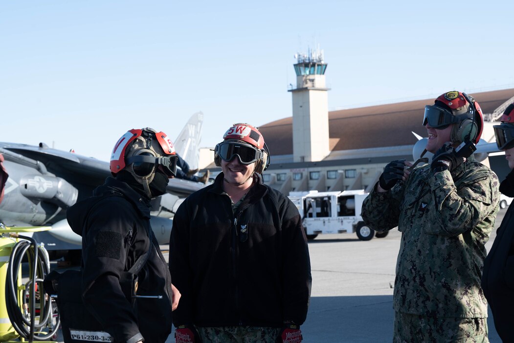 Service members conversate before pre-flight checks.