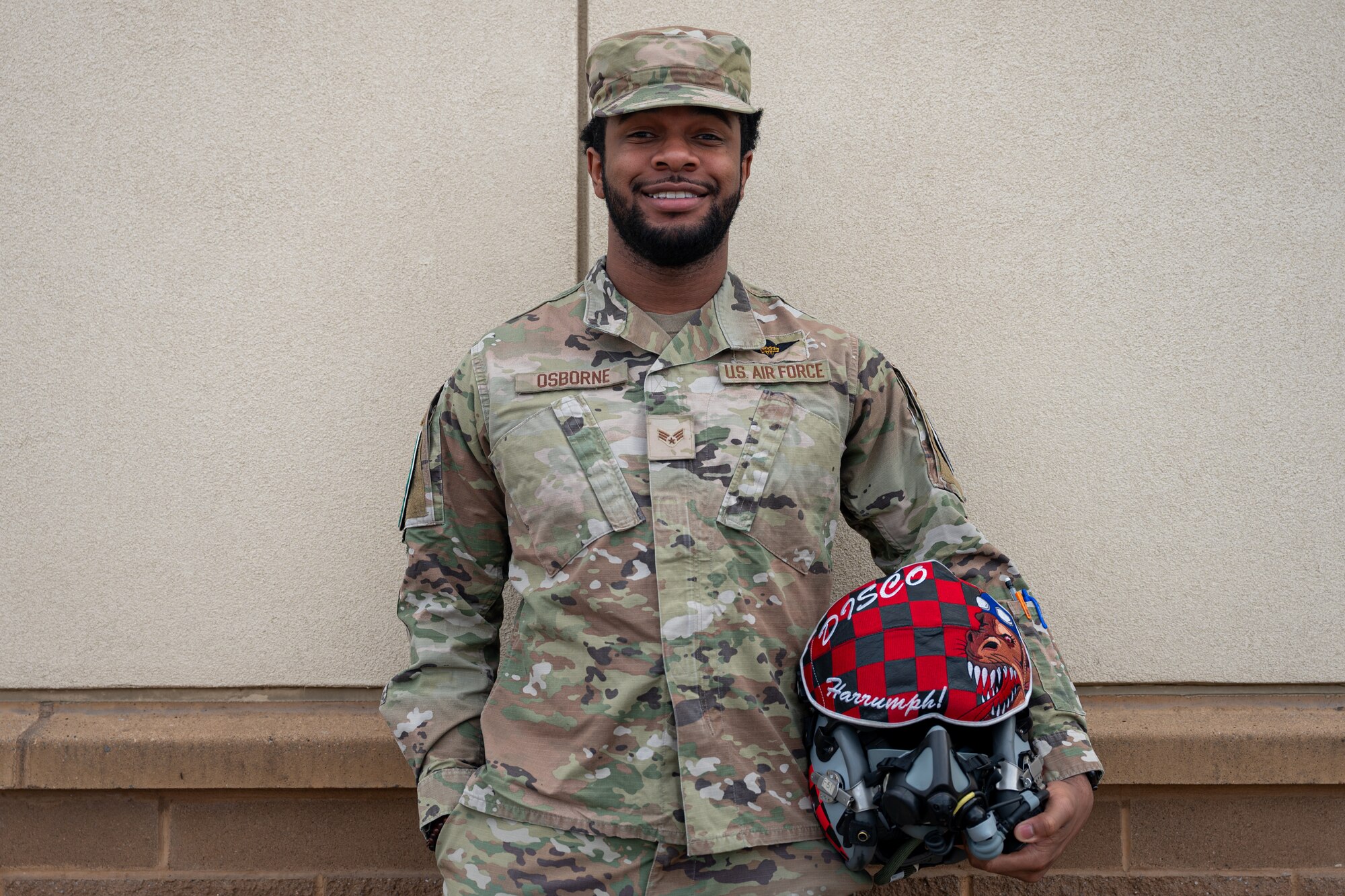 U.S. Air Force Senior Airman Rejon Osborne poses with a flight helmet.