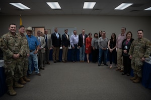 Susan Veazey, Regional Director of the Department of Defense’s Office of Local Defense Community Cooperation, takes a group photo with 27th Special Operations Wing representatives, Armed Forces Support Committee, Community leaders and stakeholders at City Hall in Clovis, N.M., April 24, 2024. OLDCC, in coordination with other federal agencies, delivers a program that enables states, local governments, and communities to plan and carry out civilian responses to workforce, business, and community needs arising from Defense actions. (U.S Air Force photo by Senior Airman Parra)