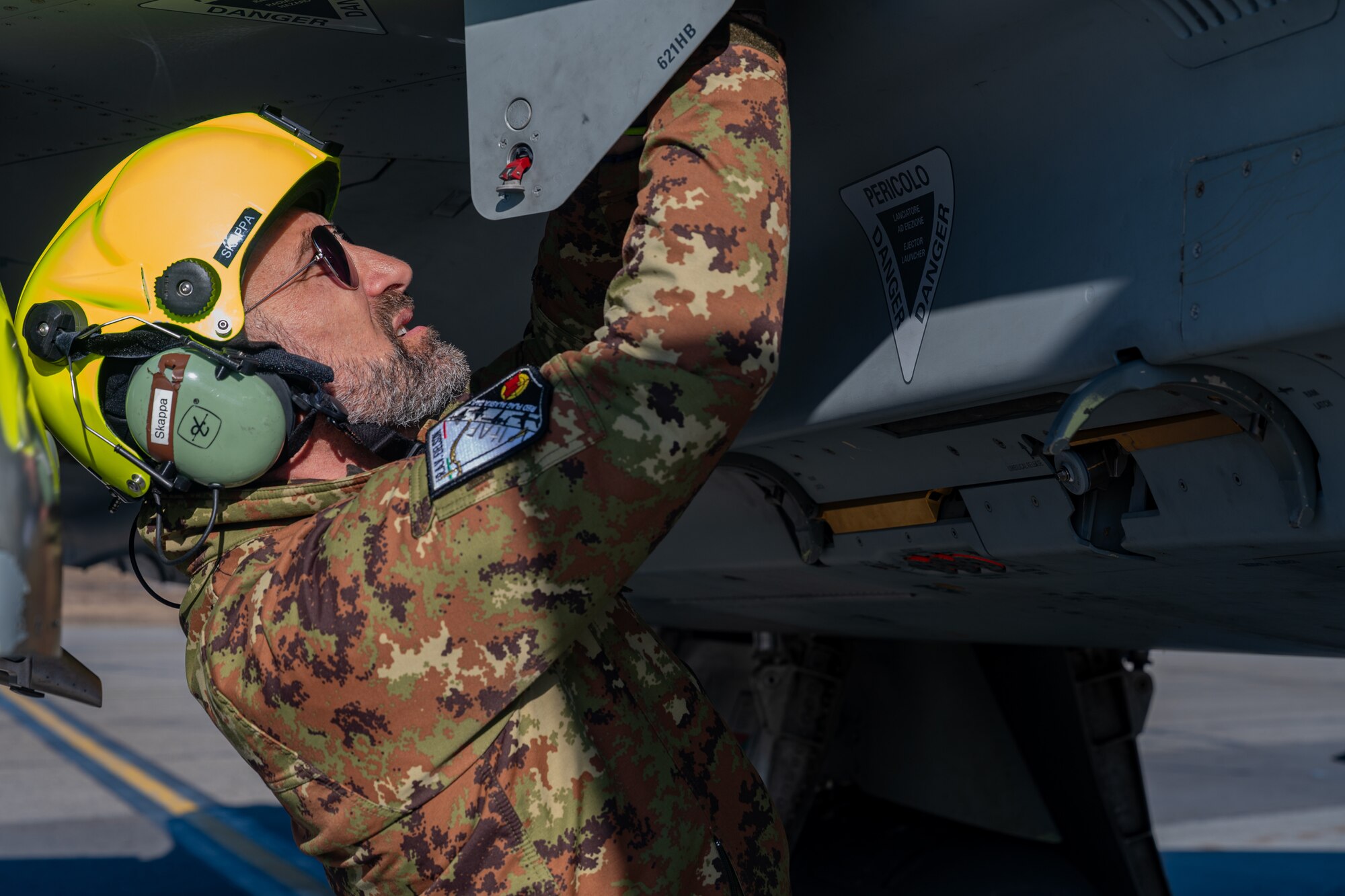 An Italian Air Force crew chief performs pre-flight checks during Red Flag Alaska 24-1.