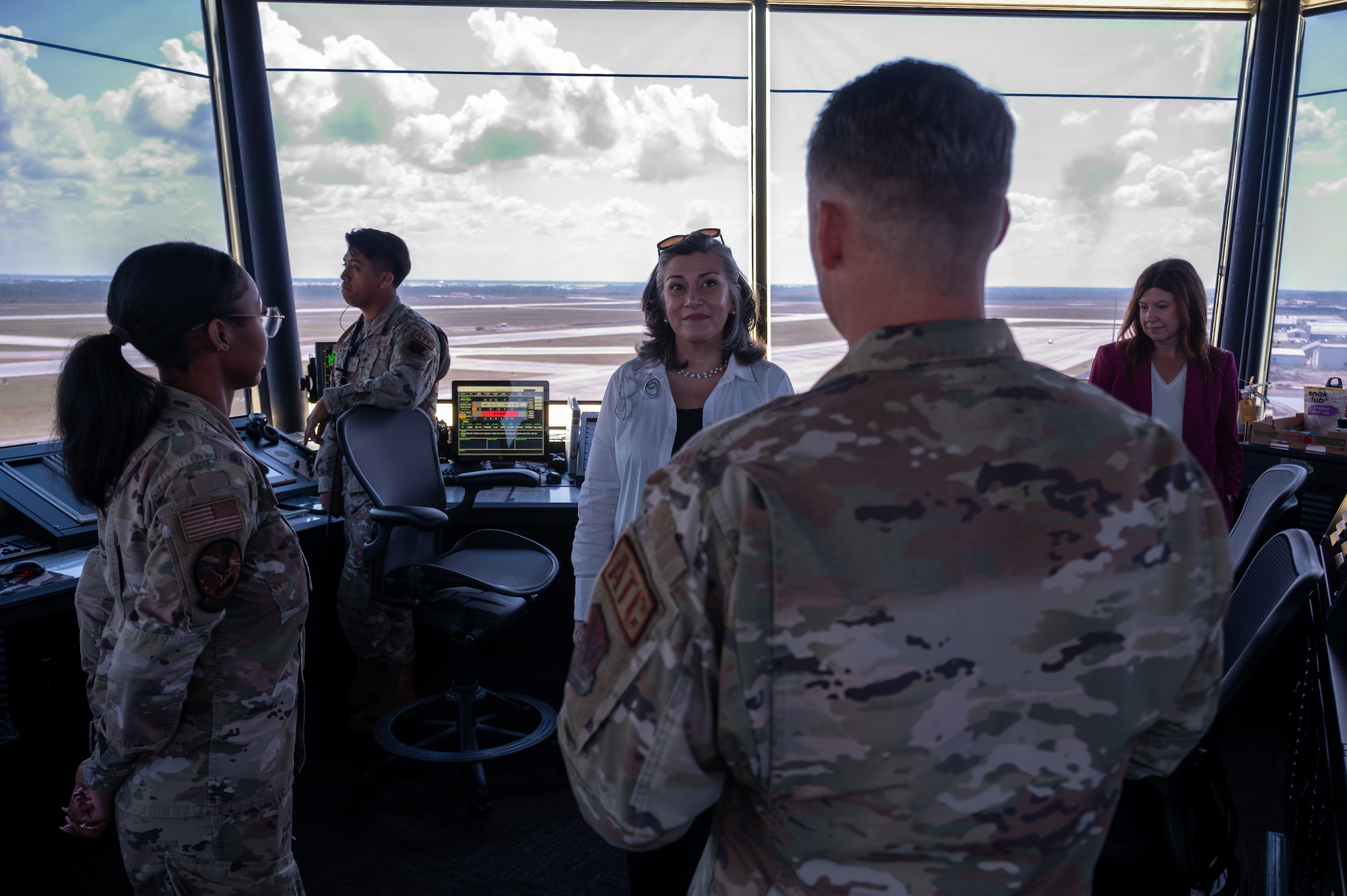 A women speaks with Airmen