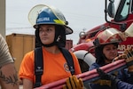 Yoselin Alejandra Orellana Ramos, a Salvadoran Firefighter II, practices hose pulls during CENTAM SMOKE at Soto Cano Air Base, Honduras, April 22, 2024. Orellana is the first female Salvadoran firefighter to participate in CENTAM SMOKE.