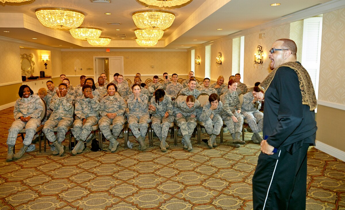 Sinbad in foreground as about 30 TIB members sit and laugh.