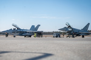 U.S. Navy and Italian Air Force service members prepare for familiarization flights during Red Flag-Alaska 24-1.