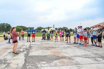 1st Lt. Jacqueline Hawkins, 59th Medical Operations Squadron social work fellow, gives opening remarks prior to an Alcohol Awareness Month 5K at Wilford Hall Ambulatory Surgical Center, Joint Base San Antonio-Lackland, Texas, April 27, 2024. The Alcohol and Drug Abuse Prevention and Treatment program offers Alcohol Brief Counseling for individuals not meeting diagnostic criteria, focusing on education about acceptable alcohol limits versus excessive consumption. Service members can access ADAPT services through self-referral, medical referral from their Primary Care Manager, or command referral. (Air Force photo by Senior Airman Melody Bordeaux)