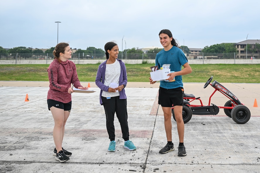 Eduardo Barajas, a 16-year-old top runner, receives a wellness basket for being the first kid to finish the Alcohol Awareness Month 5K at Wilford Hall Ambulatory Surgical Center, Joint Base San Antonio-Lackland, Texas, April 27, 2024. Barajas shared he enjoys cross country and has run in over 10 other 5Ks. (Air Force photo by Senior Airman Melody Bordeaux)