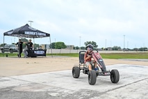 Killian Hawkins, 1st Lt. Jacqueline Hawkins’ son, wears drunk goggles and rides a quadcycle during an Alcohol Awareness Month 5K at Wilford Hall Ambulatory Surgical Center, Joint Base San Antonio-Lackland, Texas, April 27, 2024. He shared while wearing the drunk goggles he saw two of everything. To promote awareness of alcohol misuse, attendees participating in this simulation may gain an understanding of the effects of inebriation while driving. (Air Force photo by Senior Airman Melody Bordeaux)