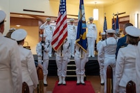 A photo of several people saluting the colors.