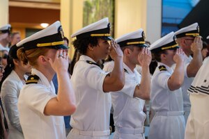 A photo of several people saluting.
