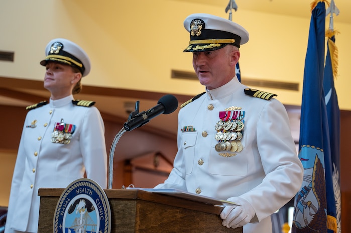 A photo of a man speaking to the crowd.