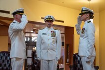 A photo of two people saluting.