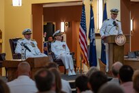 A photo of a man speaking to an audience.