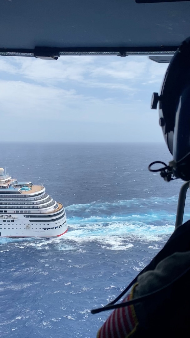 A Coast Guard Air Station New Orleans MH-60 Jayhawk helicopter aircrewman looks out at the Carnival Dream, approximately 160 miles offshore from Southwest Pass, Louisiana, April 27, 2024.