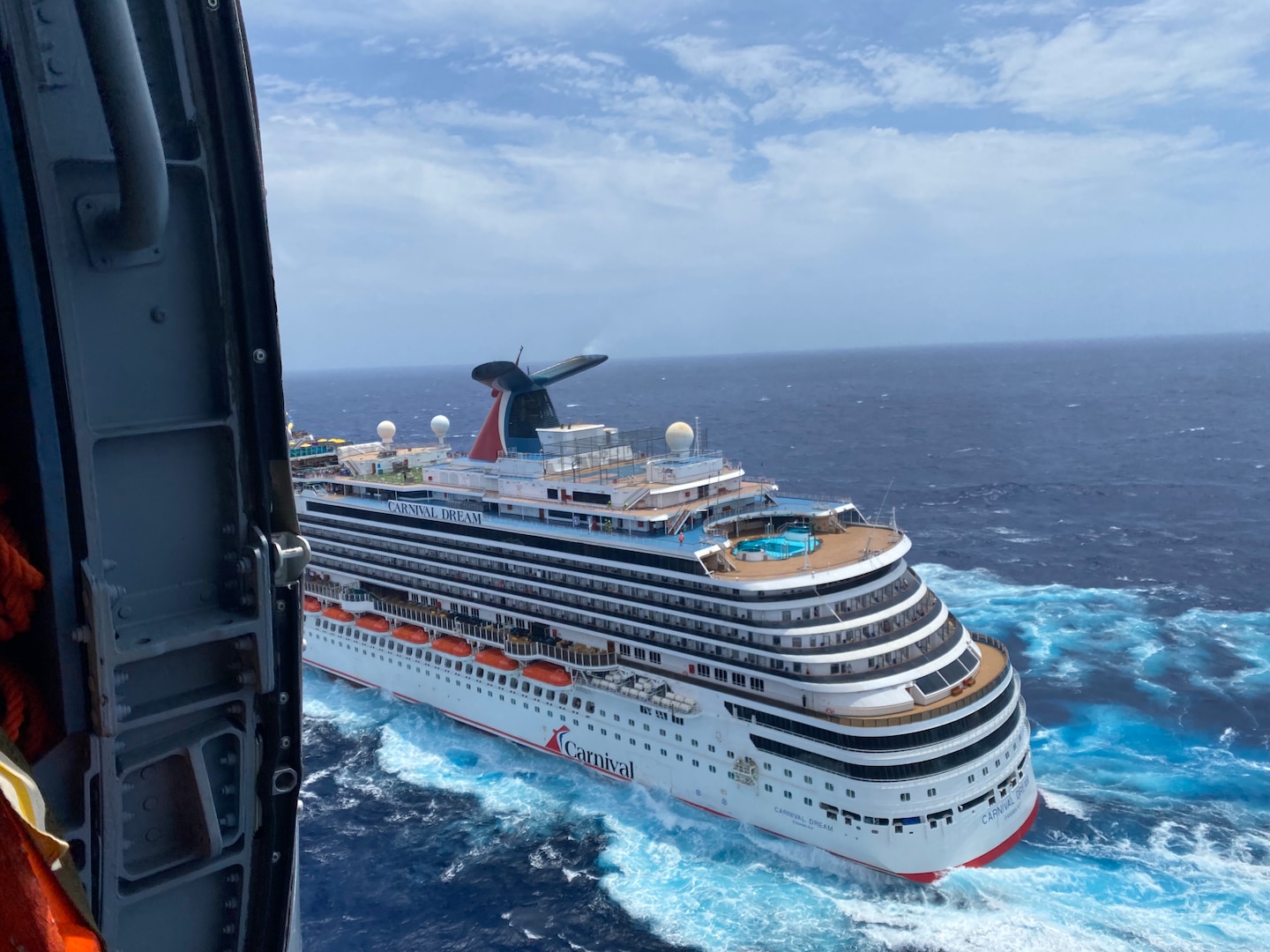Tthe Carnival Dream is seen from a Coast Guard Air Station New Orleans MH-60 Jayhawk helicopter as it flies towards the ship approximately 160 miles offshore from Southwest Pass, Louisiana, April 27, 2024.