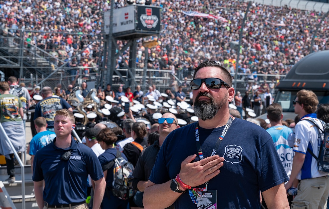 A civilian stands for the national anthem during the Würth 400 NASCAR Cup Series, at Dover Motor Speedway in Dover, Delaware, April 28, 2024. Dover Air Force Base’s Eagle Choir, Chaplain and Honor Guard were present as part of the opening ceremonies during race weekend. (U.S. Air Force photo by Airman Liberty Matthews)