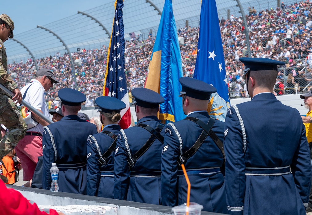 Team Dover Honor Guard members stand at attention after presenting the colors during the Würth 400 NASCAR Cup Series at Dover Motor Speedway in Dover, Delaware, April 28, 2024. Dover Air Force Base’s Eagle Choir, Chaplain and Honor Guard were present as part of the opening ceremonies during race weekend. (U.S. Air Force photo by Airman Liberty Matthews)