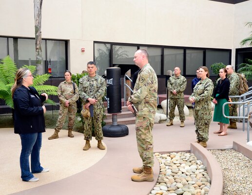 Tabitha Shannon, Naval Medical Center San Diego's Comprehensive Combat and Complex Casualty Care department's division officer, left, speaks to Uniformed Services University of Health Science Brigade leadership and team members in the rehabilitation courtyard during a tour of NMCSD, April 24, 2024. Navy Medicine Readiness and Training Command San Diego’s mission is to prepare service members to deploy in support of operational forces, deliver high quality healthcare services and shape the future of military medicine through education, training and research. NMRTC San Diego employs more than 6,000 active duty military personnel, civilians and contractors in Southern California to provide patients with world-class care anytime, anywhere. (U.S. Navy photo by Mass Communication Specialist 2nd Celia Martin)